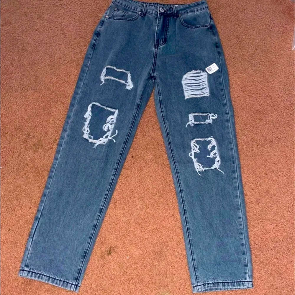 Women’s distressed blue straight leg jeans. 24” waist